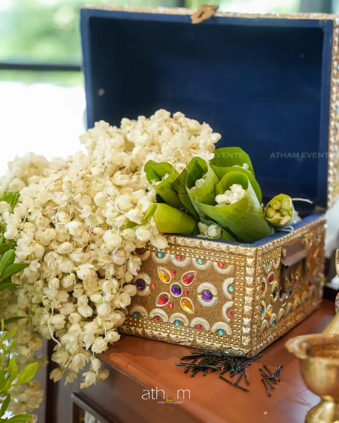 Jasmine wedding garlands and ceremonial details in an ornate box