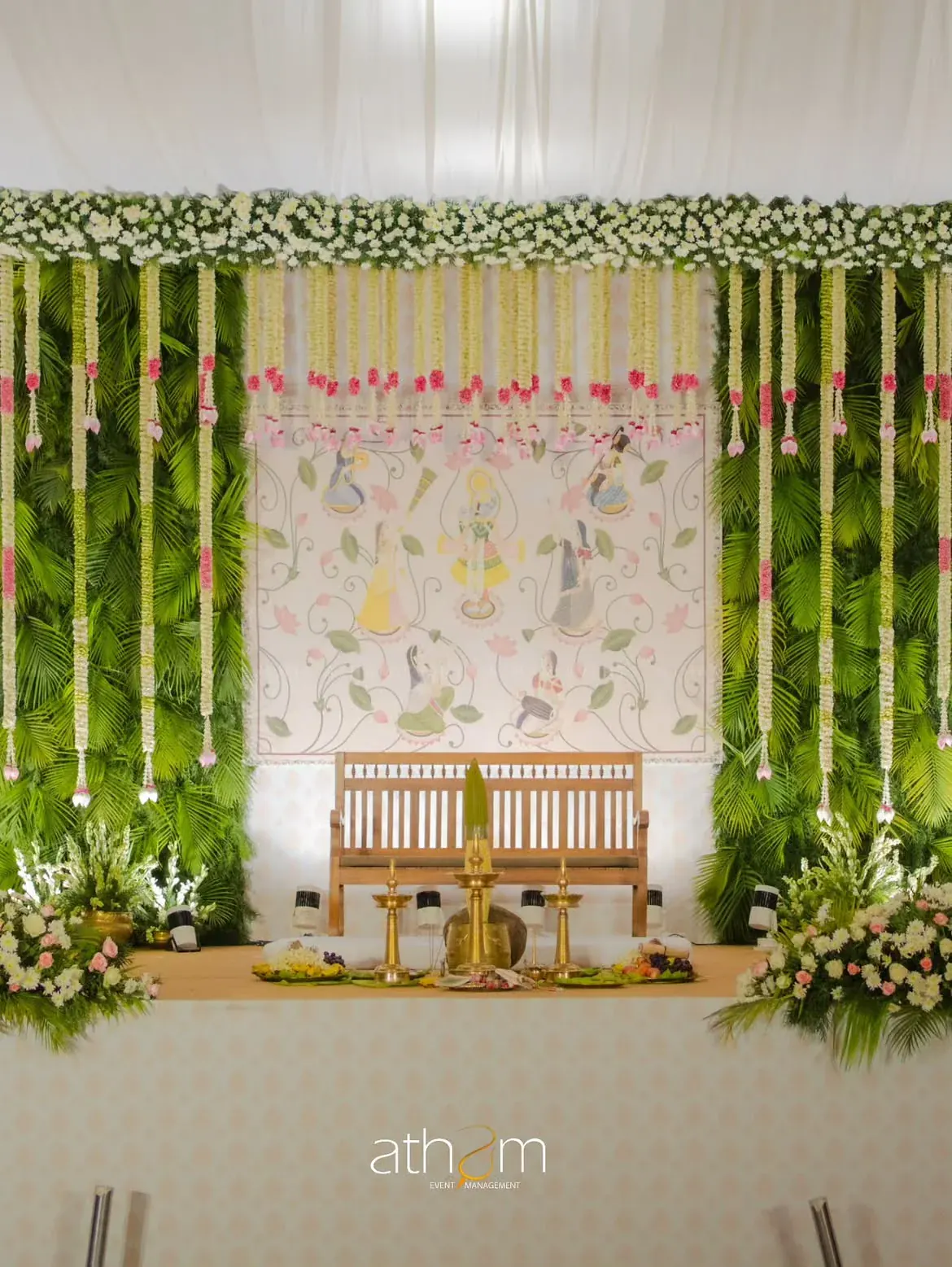 Green and white floral Kerala wedding mandap with brass ceremonial décor