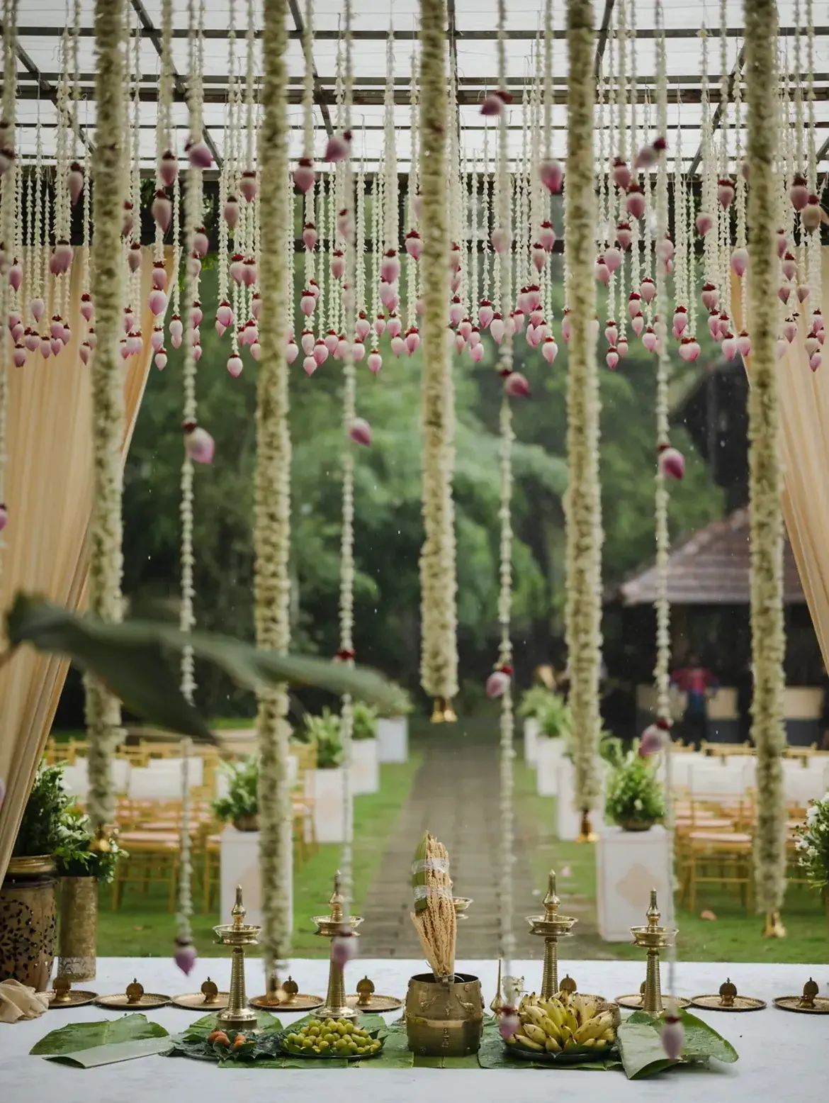 Outdoor Kerala wedding ceremony decorated with jasmine garlands