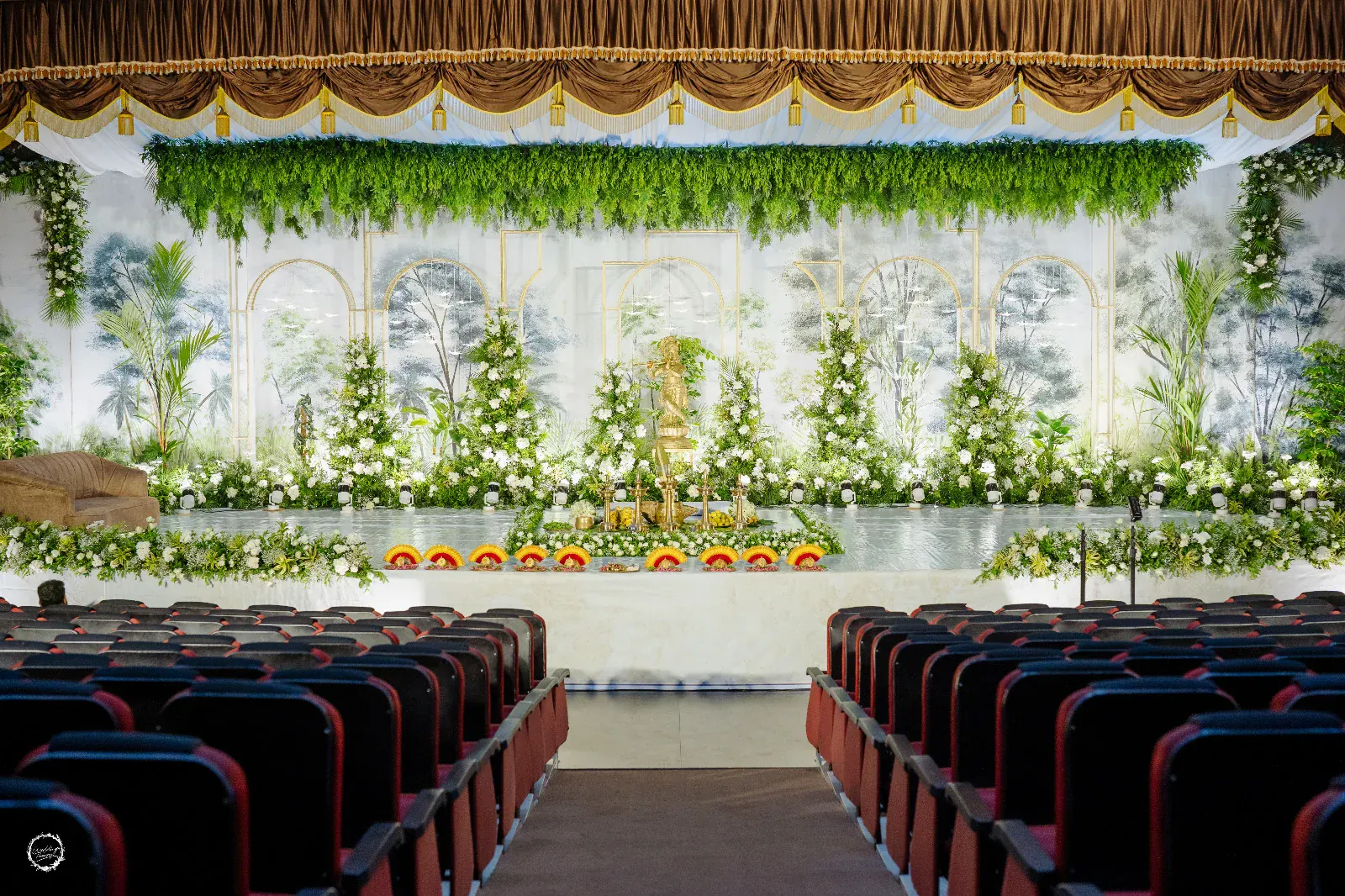 Botanical green and white wedding stage with garden-inspired backdrop