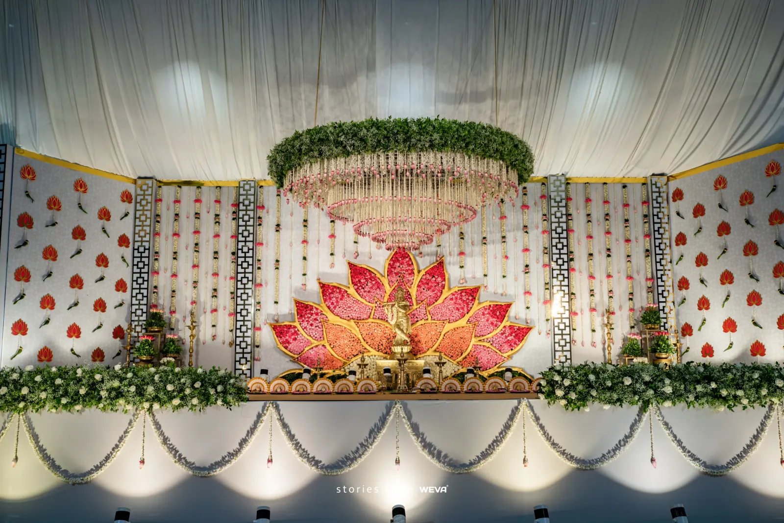 Pink lotus wedding stage with hanging floral chandelier