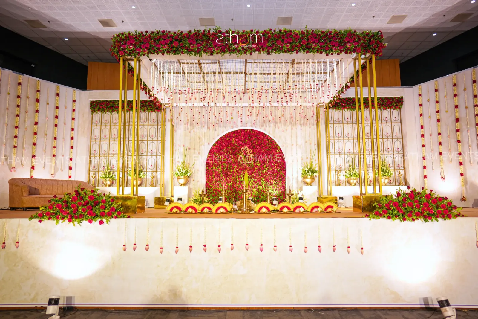 Red rose floral canopy wedding stage with gold framework