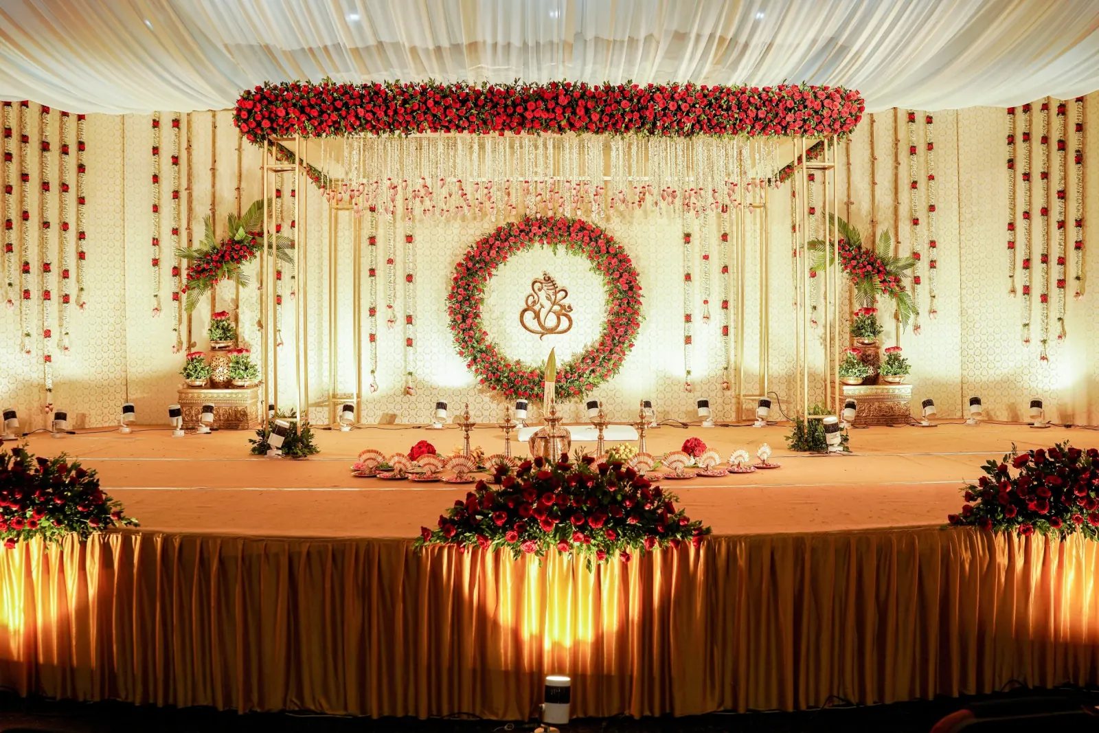 Red rose ring wedding stage with jasmine canopy and gold framework